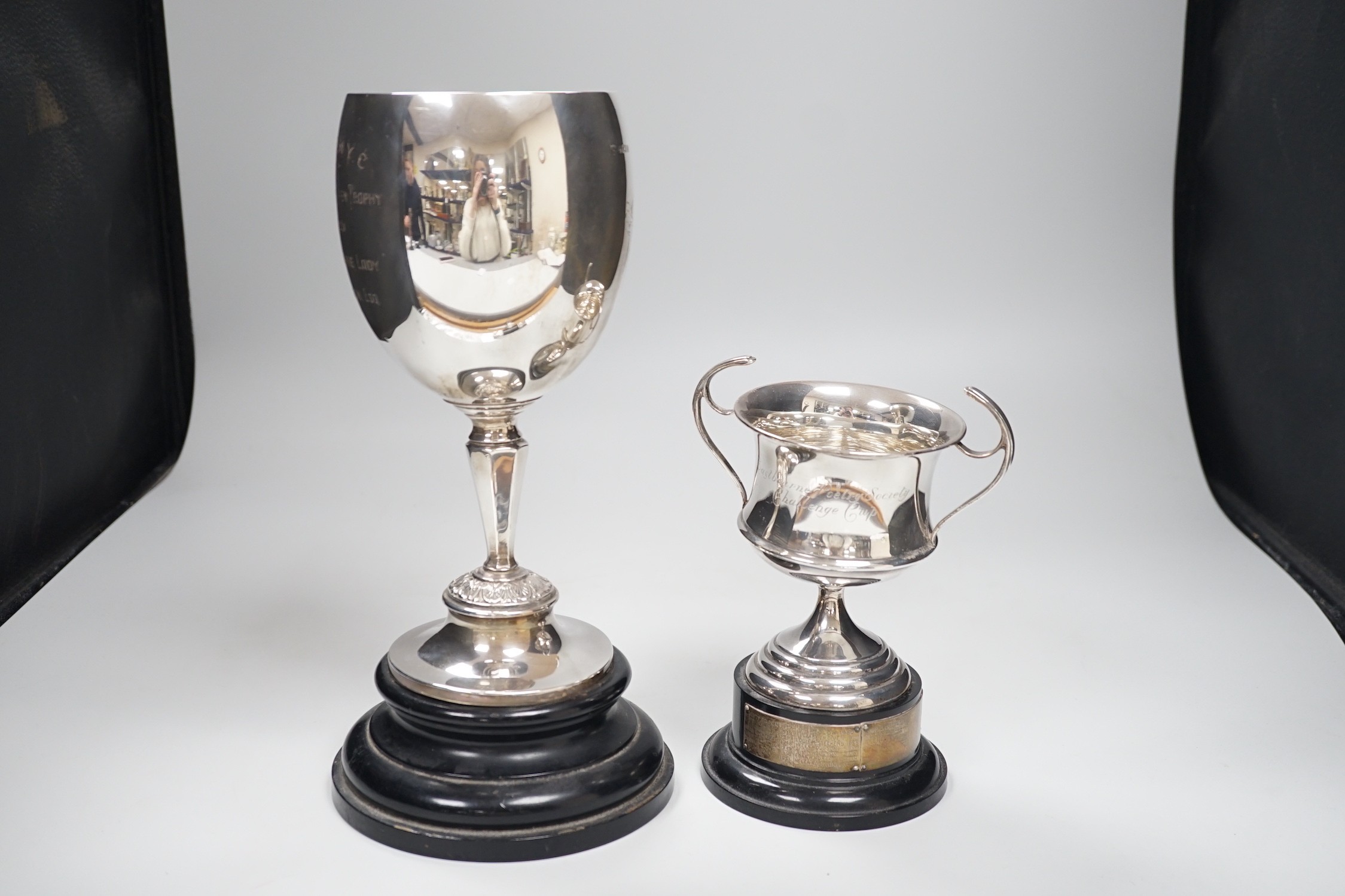 A silver trophy cup inscribed 'Winner Divine Lady', Birmingham 1932, 24.5cm, 10oz and a smaller two handled trophy cup 'Eastbourne Poetry Society Challenge Cup' (London 1914), 5oz